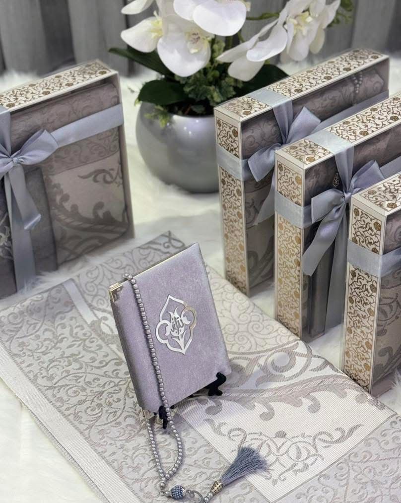 A prayer mat containing a portion of the Quran with prayer beads.